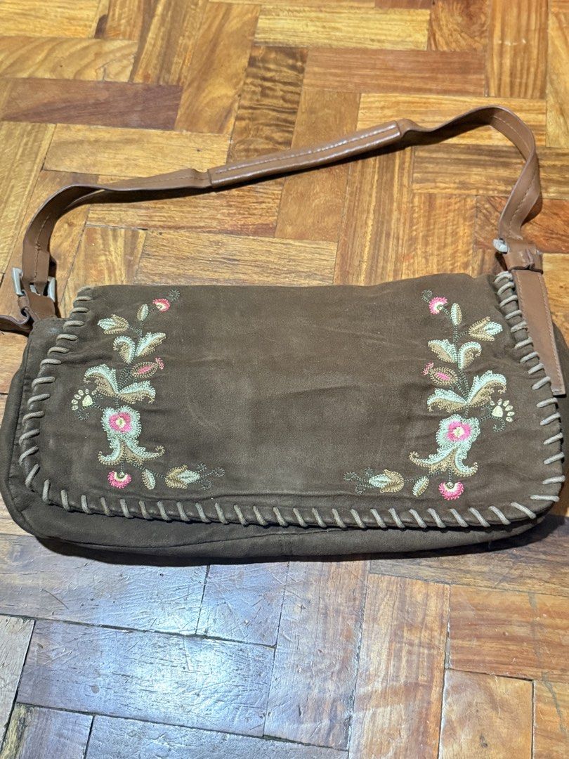 Brown Suede Embroidered Floral Shoulder Bag (Category: Shoulder Bags) located in Manila. Submitted by only_alyssacloset (Listing ID 1469646447, Image 2). Description: Style: Bohemian earth-toned shoulder bag Material: Brown suede with whipstitch trim and faux leather adjustable strap Size: Medium.