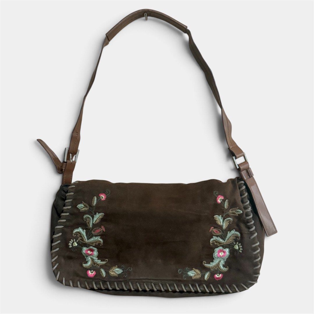 Brown Suede Embroidered Floral Shoulder Bag (Category: Shoulder Bags) located in Manila. Submitted by only_alyssacloset (Listing ID 1469646447, Image 1). Description: Style: Bohemian earth-toned shoulder bag Material: Brown suede with whipstitch trim and faux leather adjustable strap Size: Medium.