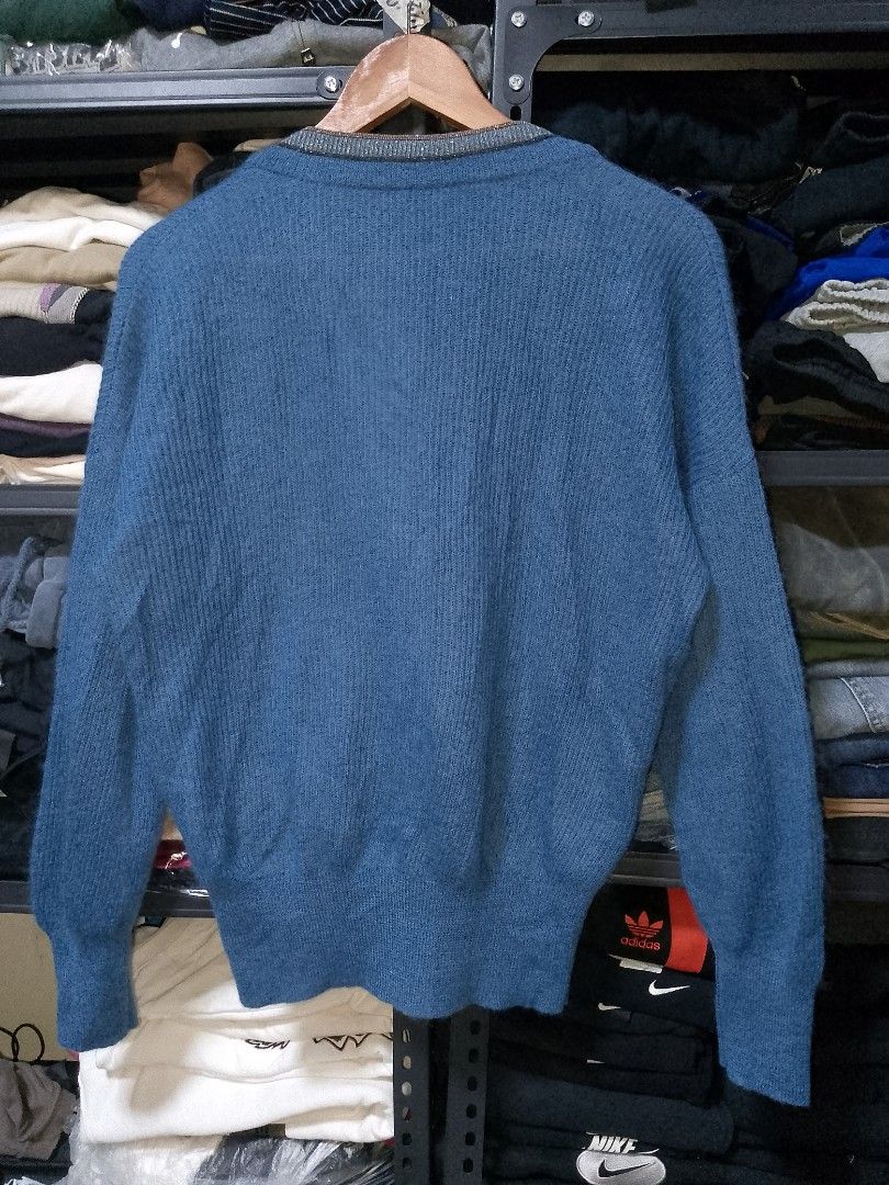 Brunello Cucinelli Blue Mohair Cardigan (Category: Coats, Jackets and Outerwear) located in Manila. Submitted by mjthrifted_second (Listing ID 1469643116, Image 2). Description: - Brand: Brunello Cucinelli - Origin: Made in Italy -Size: Large -Dimes: 21/26 - Material: Luxurious mohair, virgin wool, and polyamide blend - Design: Blue knit cardigan with elegant shimmery trim along the V-neck and button placket - Features: Long sleeves, ribbed cuffs