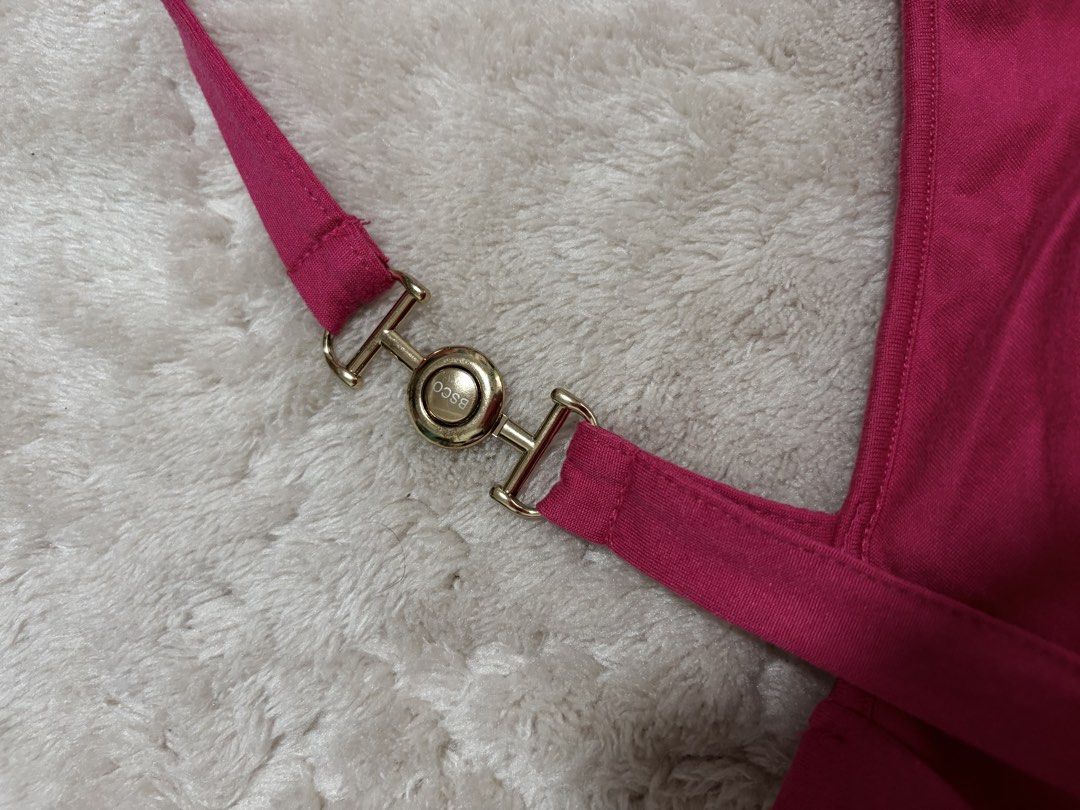BSCO Orion top Size Large (Category: Sleeveless) located in Mandaluyong City. Submitted by sckyomiii (Listing ID 1469586541, Image 2). Description: - Brand: BSCO - Style: Halter neck top with chic gold-tone hardware clasp - Design: Trendy all-over ruching in a vibrant magenta/pink hue - Material: Soft and stretchy fabric for a comfortable fit - Condition: Great, clean, and ready to wear.