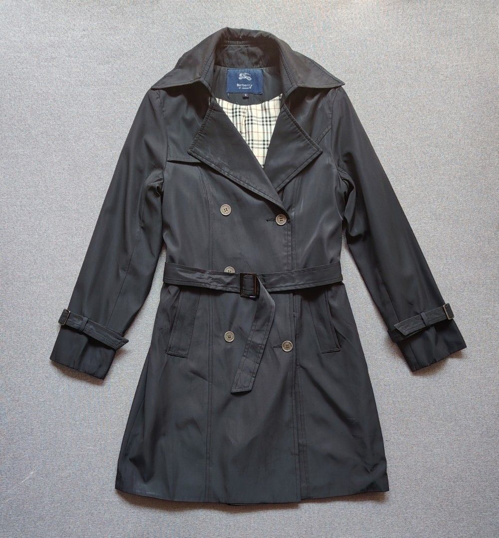 Burberry Double Brested Trench Coat (Category: Coats, Jackets and Outerwear) located in Taguig. Submitted by _theroom.ph (Listing ID 1469636775, Image 1). Description: Burberry London trench coat in black, size M. Double-breasted front with branded buttons. Matching waist belt and adjustable sleeve straps. Classic check lining inside. Main fabric 83% cotton, 15% nylon, 2% elastane. 100% cupro lining. Made in Hong Kong. Dry clean only, remember to