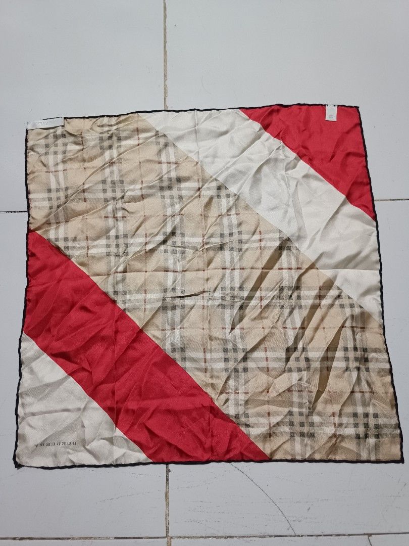 Burberry London Silk handkerchief (Category: Scarves) located in Barotac Nuevo. Submitted by gray101 (Listing ID 1469696744, Image 2). Description: Burberry London silk handkerchief. Classic house check pattern mixed with red and white diagonal color block sections. Hand-rolled black edges. Includes original brand and material tags sewn on corners. 100% silk fabric with a smooth sheen. Square shape..
