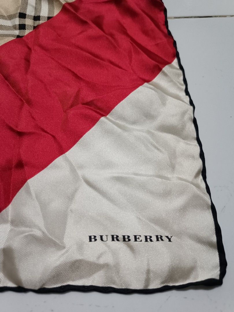 Burberry London Silk handkerchief (Category: Scarves) located in Barotac Nuevo. Submitted by gray101 (Listing ID 1469696744, Image 3). Description: Burberry London silk handkerchief. Classic house check pattern mixed with red and white diagonal color block sections. Hand-rolled black edges. Includes original brand and material tags sewn on corners. 100% silk fabric with a smooth sheen. Square shape..