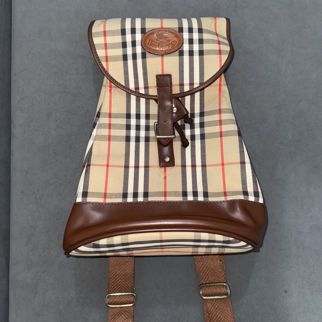 Burberry Vintage Nova Check / Haymarket Check Backpack (Category: Luxury Bags & Wallets) located in Calasiao. Submitted by jafaith_man (Listing ID 1469710062, Image 1). Description: Burberry Vintage Nova Check / Haymarket Check Backpack featuring a beige signature check canvas, brown leather trim, and a buckled flap closure..
