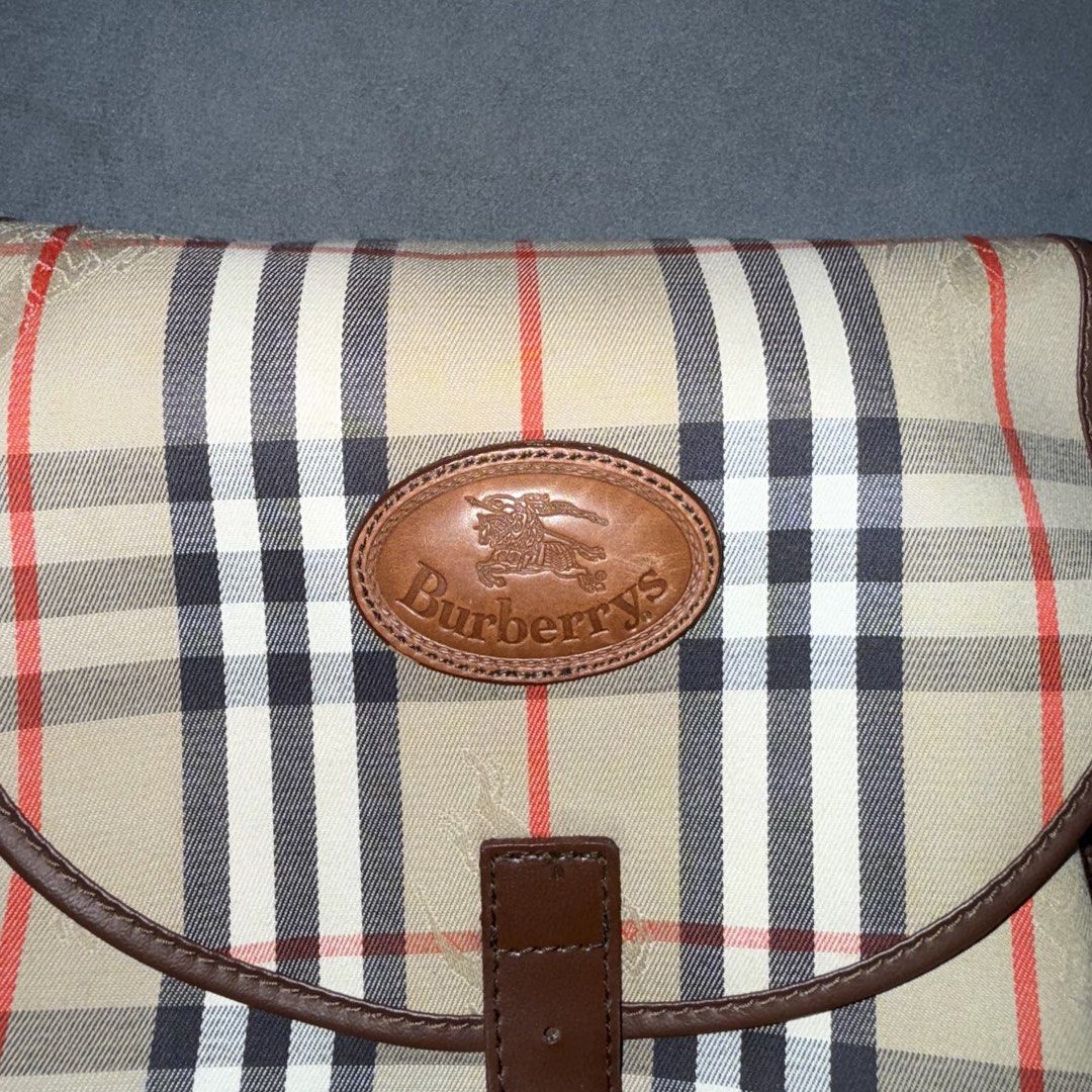 Burberry Vintage Nova Check / Haymarket Check Backpack (Category: Luxury Bags & Wallets) located in Calasiao. Submitted by jafaith_man (Listing ID 1469710062, Image 3). Description: Burberry Vintage Nova Check / Haymarket Check Backpack featuring a beige signature check canvas, brown leather trim, and a buckled flap closure..