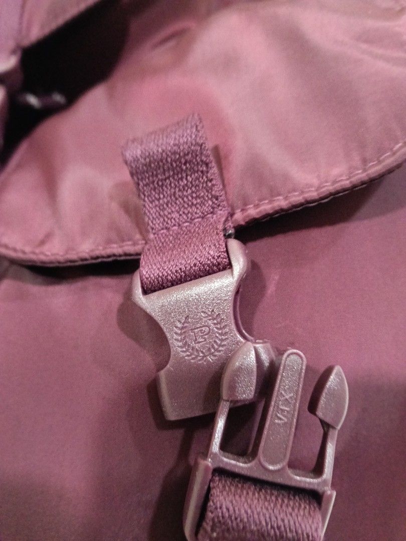Burgundy nylon rucksack backpack with front pockets and buckle closure (Category: Backpacks) located in Manila. Submitted by zenbear_6b2d8a (Listing ID 1469586498, Image 2). Description: - Color: Stylish burgundy - Material: Durable nylon with pale pink fabric interior - Closure: Secure drawstring with patterned cord and heavy-duty plastic buckle flap - Storage: Main compartment, interior zippered pocket, and two front buckle pockets - Comfort: A