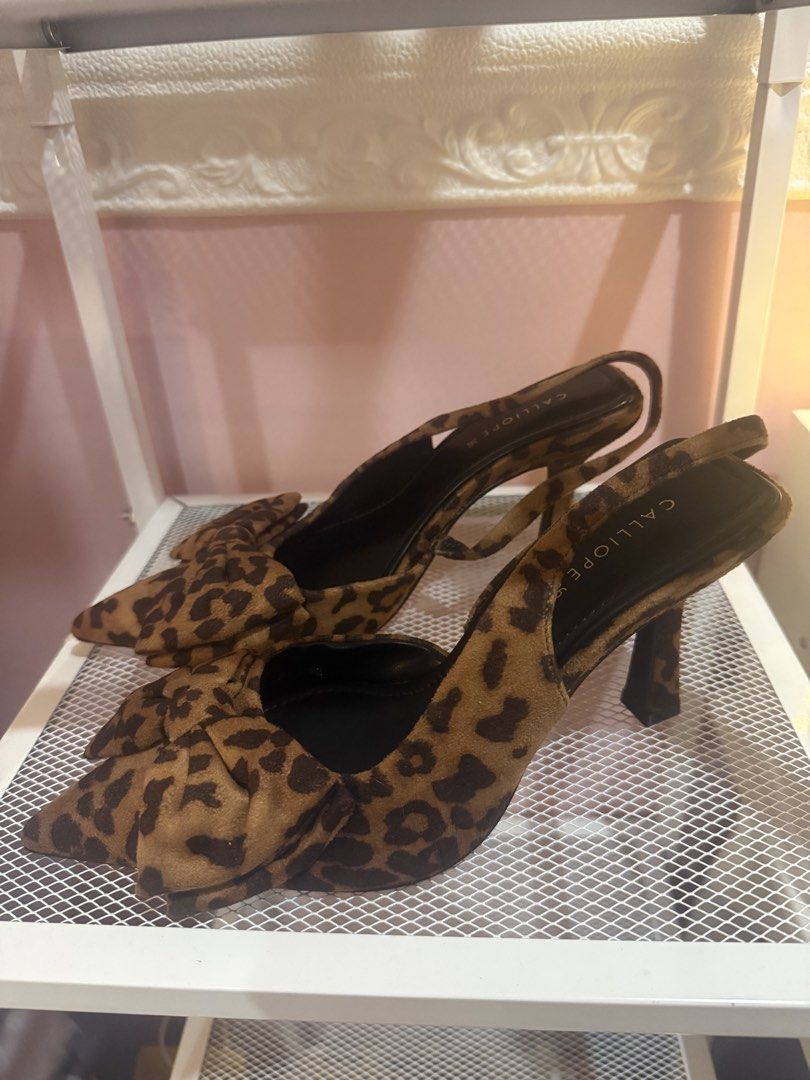 Calliope Leopard Print Bow Heels Size 36 (Category: Heels) located in Bacoor. Submitted by micsr (Listing ID 1469639308, Image 1). Description: - Brand: Calliope - Size: 36 (with black branded inner sole) - Design: Fierce leopard print with a cute front bow and pointed toe - Fit: Secure slingback strap - Heel: Sturdy and comfortable height - Occasion: Perfect for parties, dates, or dressing up a simple denim outfit.