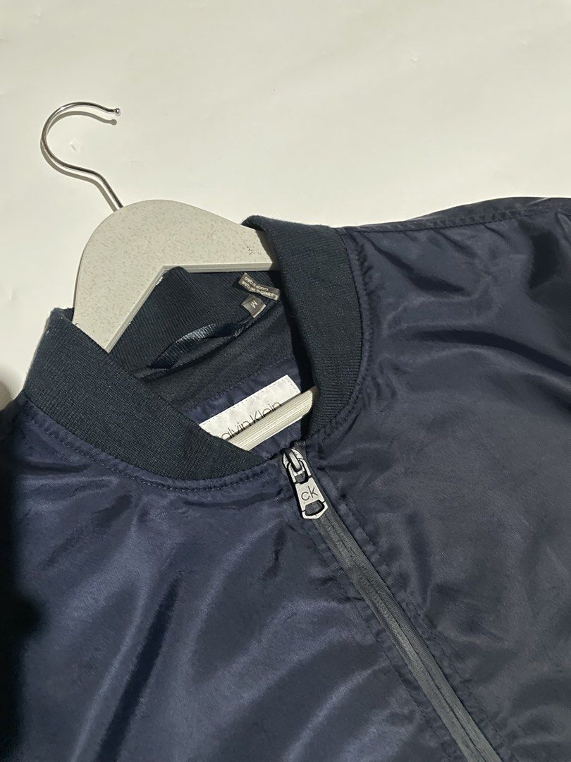 Calvin klein bomber jacket (Category: Coats, Jackets and Outerwear) located in Bais. Submitted by christian.complexthrift08 (Listing ID 1469755888, Image 2). Description: Calvin Klein bomber jacket (Perfect for daily use) Color: Navy blue Size: M on tag Width: 24 inches Length: 27 inches Condition: 9.5 / 10 Issue: Price: 1199 free shipping Via JNT express.