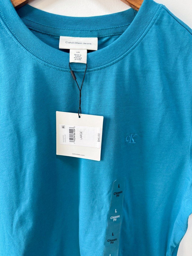 Calvin Klein Crew Neck T-shirt (Category: Shirts) located in Taguig. Submitted by curatedfinds_jd (Listing ID 1469654078, Image 3). Description: 🏷️Condition: Brandnew with tag 💰Price: ₱1,200 📏Size: Large Length: 28.5 in Width: 21.5 in 📍Location: New Lower Bicutan, Taguig City 🛵Courier: J&T or Lalamove.