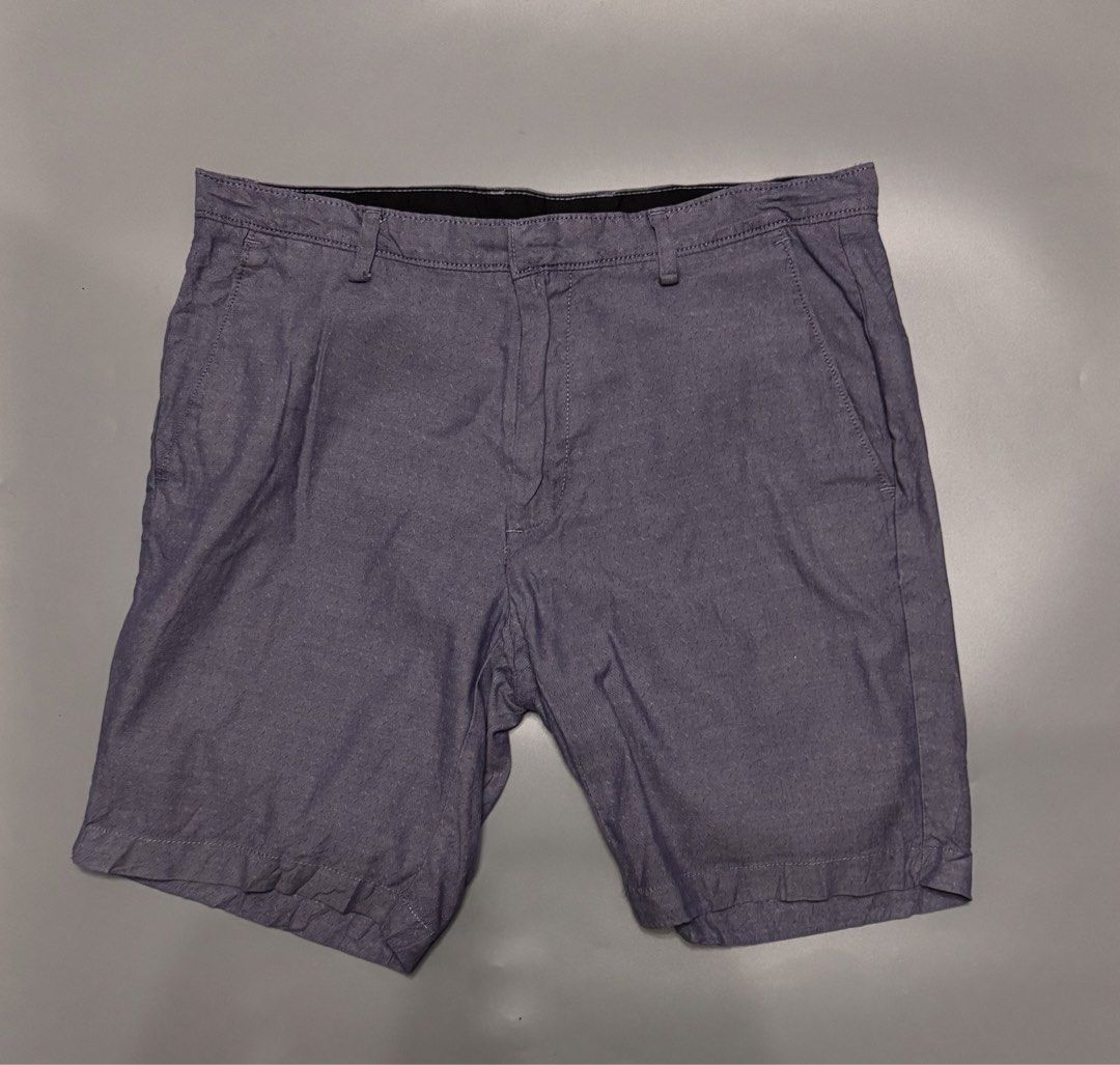 Calvin Klein Grey Blue Shorts Size 32 (Category: Shorts) located in Alaminos. Submitted by outfitcheck.ph (Listing ID 1469698072, Image 1). Description: - Brand: Calvin Klein - Size: Men's 32 - Color: Blue-Grey - Closure: Standard button and zip with belt loops - Pockets: Two front pockets and two back welt pockets - Details: Subtle metal logo badge on the right back pocket - Condition: Clean inside lining with printed brand label.