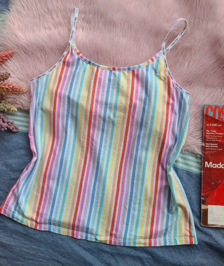 Calvin Klein Multicolored Striped Cami Tank Top (Category: Sleeveless) located in Lingayen. Submitted by chloeswhite (Listing ID 1469607945, Image 1). Description: Multicolor striped cami top by Calvin Klein. White straps feature printed Calvin Klein branding. Scoop neckline. Measures around 15 inches across the chest and 22 inches in total length. Soft cotton blend material. Super cute pastel rainbow stripe pattern. Great basic piece for warm we