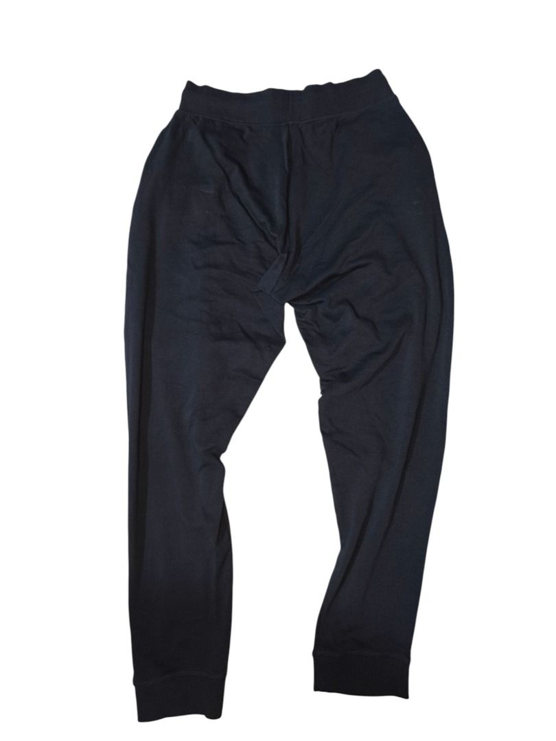 Calvin Klein Navy Logo Sweatpants (Category: Joggers) located in Baguio. Submitted by boneteezandharmony (Listing ID 1469663367, Image 3). Description: Minimalist navy blue Calvin Klein sweatpants featuring bold contrast branding along the leg, cream drawstrings, and ribbed waistband and ankle cuffs. A clean, comfortable piece for casual everyday fits. Tagged Calvin Klein Sleepwear, made in Bangladesh. Condition: 8/10 Dimes: 15 × 39 .