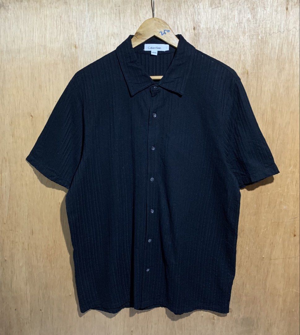 Calvin Klein seersucker short-sleeve button-down (Category: Tshirts & Polo Shirts ) located in Cebu City. Submitted by handpickedxthrift (Listing ID 1469693482, Image 1). Description: Calvin Klein seersucker short-sleeve button-down Good as new 22 x 29 No issue Color rate 10/10 DM interested📩.