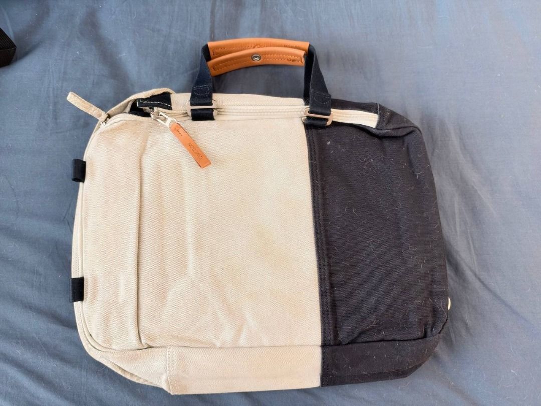 Canvas Two-Tone Convertible Backpack Briefcase (Category: Backpacks) located in Caloocan City. Submitted by raymon_3303 (Listing ID 1469603855, Image 1). Description: - Two-tone canvas design in cream and black with stylish brown leather details - Can be worn as a backpack or carried as a briefcase - Roomy main section easily fits books, documents, or a laptop - Multiple inner zippered compartments to keep your essentials organized - Adjustable s