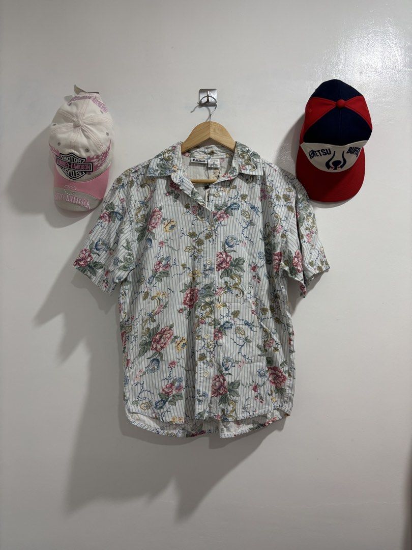Capacity Floral Striped Short Sleeve Shirt (Category: Shirts) located in Calbayog City. Submitted by zaxcheus_castillo1708 (Listing ID 1469669778, Image 1). Description: - Brand: Capacity - Size: Small (Tag still attached) - Material: 100% Cotton, Made in Turkey - Design: Short sleeves, pointed collar, button-down front - Pattern: Light blue vertical stripes with all-over pink and yellow floral print - Condition: Brand new with tags.