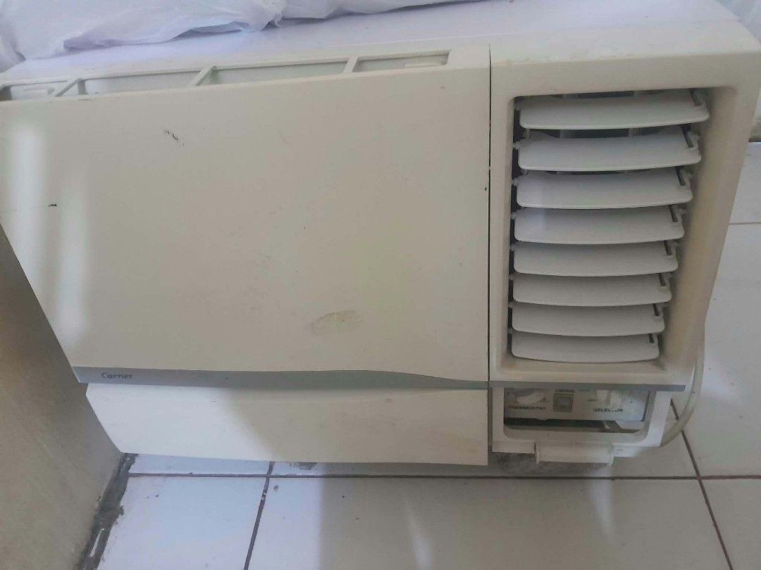 Carrier Window Type Air Conditioner (Category: Air Conditioning and Heating) located in Manila. Submitted by royalwhale_636cf8 (Listing ID 1469588657, Image 2). Description: - Brand: Carrier window aircon - Color: Off-white finish - Controls: Standard manual knobs for thermostat and mode - Airflow: Adjustable horizontal louver vents - Condition: Minor scuffs and marks from previous use - Setup: Ready for wall or window mounting.