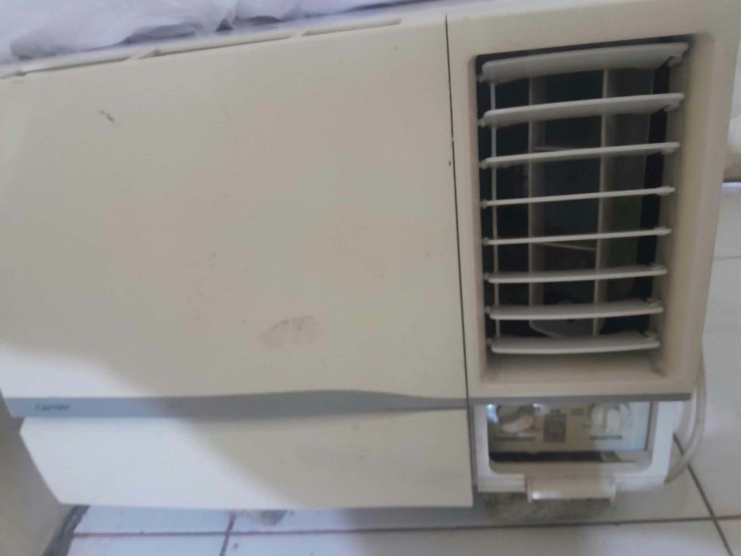 Carrier Window Type Air Conditioner (Category: Air Conditioning and Heating) located in Manila. Submitted by royalwhale_636cf8 (Listing ID 1469588657, Image 3). Description: - Brand: Carrier window aircon - Color: Off-white finish - Controls: Standard manual knobs for thermostat and mode - Airflow: Adjustable horizontal louver vents - Condition: Minor scuffs and marks from previous use - Setup: Ready for wall or window mounting.