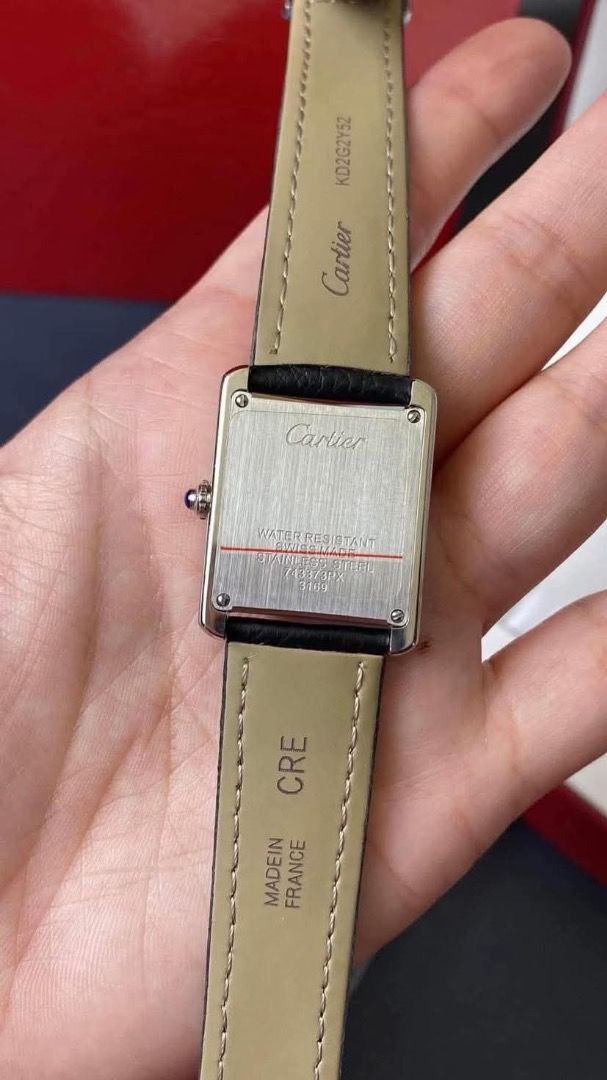 Cartier Tank Watch Black Leather Strap (Category: Luxury Watches) located in Caloocan City. Submitted by mrbigdreams (Listing ID 1469592734, Image 3). Description: - Brand: Cartier Tank Watch - Dial: Classic white textured face with Roman numerals and blue hands - Crown: Signature blue cabochon crown - Strap: Black leather strap with Cartier branding and French manufacturing stamp - Case Back: Stainless steel with engravings and water resistance 