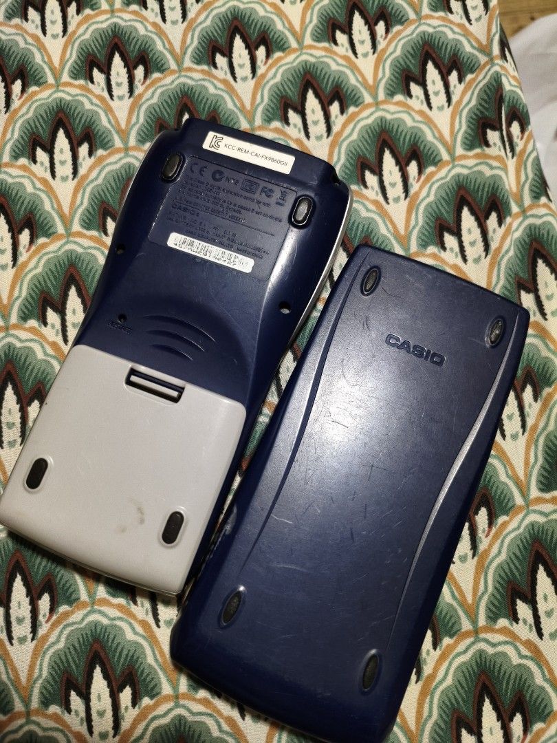 Casio fx-9860GII SD Graphing Calculator (Category: Office & Business Technology) located in Lubao. Submitted by aczcollectibles (Listing ID 1469616888, Image 2). Description: Casio fx-9860GII SD graphing calculator in working condition. Screen turns on and displays the main menu clearly. Buttons are all intact with legible text markings. Includes the hard protective slide cover. Standard scientific and graphing functions available. Battery compar