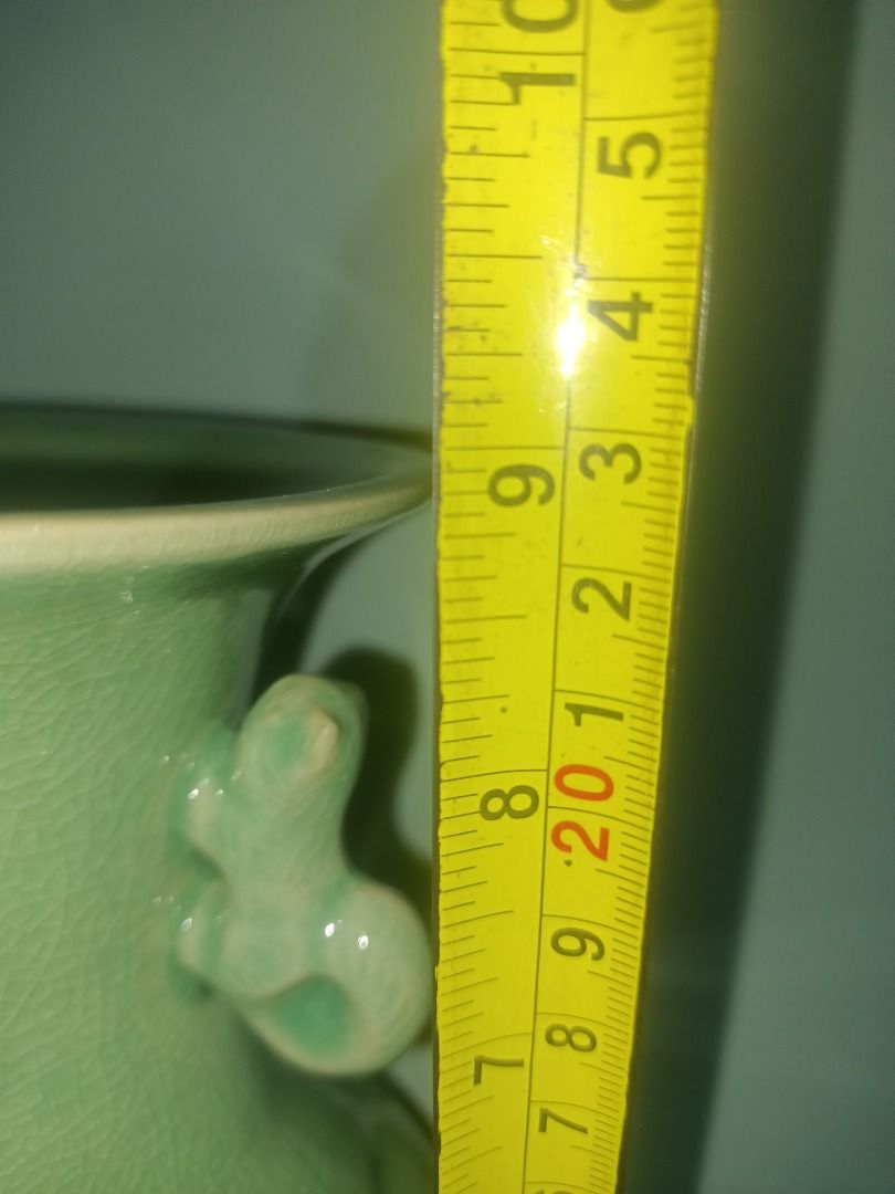 Celadon Glaze Reticulated Ceramic Vase with Handles (Category: Vases & Decorative Bowls) located in Munoz. Submitted by larryc1212 (Listing ID 1469679847, Image 2). Description: - Material: Solid ceramic pottery with green celadon glaze - Height: Approximately 9 inches - Design: Two decorative handles near the flared rim - Detail: Geometric cut-out openwork pattern on the lower bulbous body - Finish: Fine crackle glaze texture across the surface 