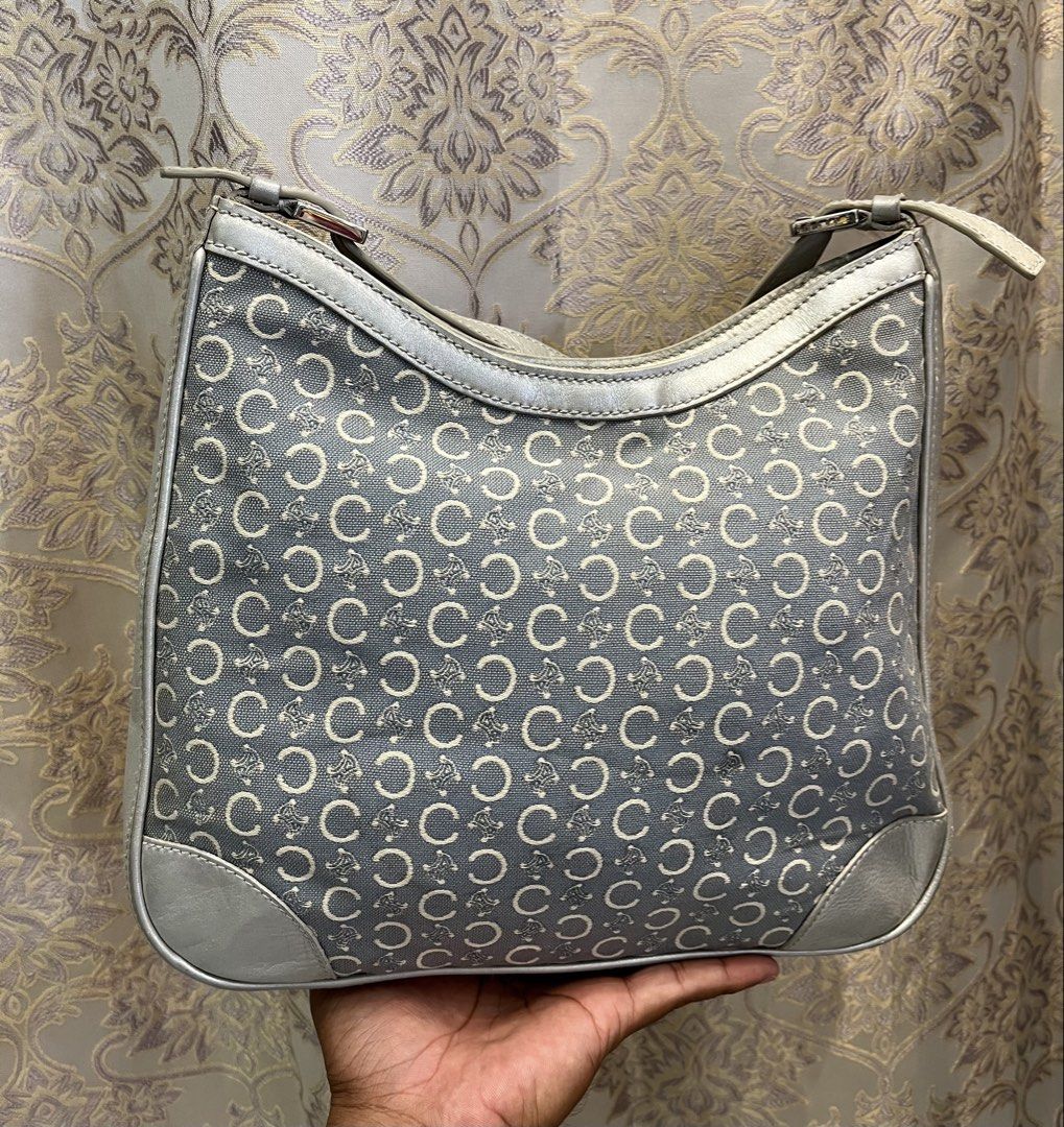 Celine C Monogram Silver Leather Canvas Shoulder Bag (Category: Luxury Bags & Wallets) located in General Santos City (Dadiangas). Submitted by thiftnibadi3 (Listing ID 1469665003, Image 3). Description: - Authentic grey canvas shoulder bag with classic all-over C monogram pattern - Eye-catching silver metallic leather trim and piping details - Secure top zipper closure to keep your essentials safe - Adjustable shoulder strap with stylish buckle 