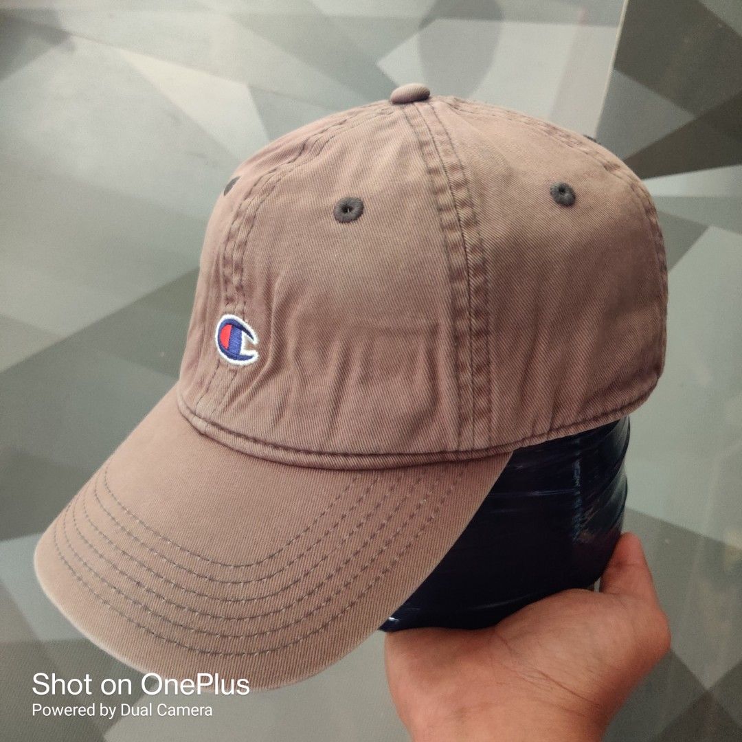 Champion classic twill dad hat (Category: Caps & Hats) located in Baguio. Submitted by ferns_garage.0924 (Listing ID 1469627082, Image 2). Description: Champion classic twill dad hat. It features a six-panel dad fit construction with unstructured canvas 100% cotton, matching embroidered ventilation eyelets, and the classic embroidered Champion "C" patch logo centered on the front dome. color faded cement grey sign of use(not brand new) scan pics 