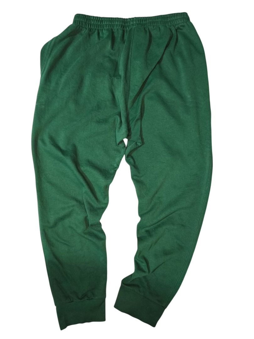 Champion Dark Green Logo Sweatpants (Category: Activewear) located in Baguio. Submitted by boneteezandharmony (Listing ID 1469663112, Image 3). Description: Classic dark green Champion sweatpants featuring the signature embroidered C logo, elastic waistband with drawstring, side pockets, and ribbed ankle cuffs. Made in Pakistan. Condition: 9/10 Size on tag: 2XL Dimes: 18 × 44.