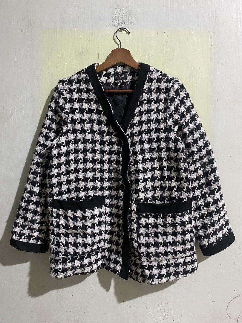 Chanel Black and White Houndstooth Tweed Jacket (Category: Coats, Jackets and Outerwear) located in Pandi. Submitted by nasya_thrift_collection2023 (Listing ID 1469716891, Image 1). Description: - Style: Classic black and white houndstooth tweed jacket - Design: Structured collarless fit with elegant contrasting black trim - Details: Two front patch pockets and front button closure - Lining: Fully lined in black fabric with Chanel brand label - V