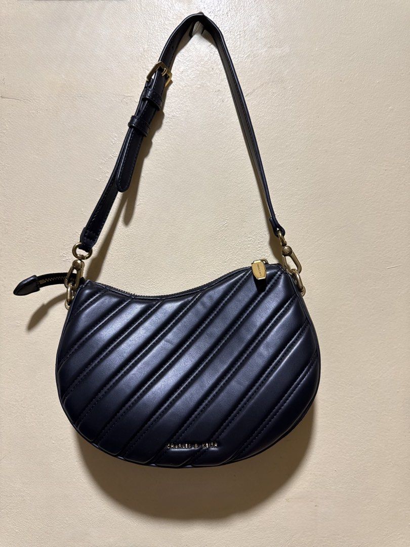 Charles & Keith (Category: Luxury Bags & Wallets) located in Taguig. Submitted by pepperonia_01 (Listing ID 1469588288, Image 2). Description: Charles & Keith Freja Curved Panelled Bag Like new Product Details -curved silhouette and panelled exterior. -Swinging from a bag strap with gold-tone chunky chain-links -Material: Faux leather.