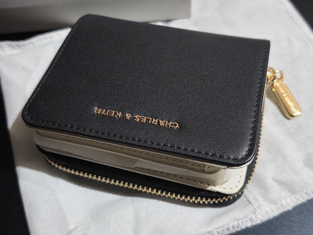 Charles & Keith wallet (black & white) (Category: Wallets & Card holders) located in Makati City. Submitted by randomelle (Listing ID 1469659300, Image 1). Description: Please read !!! For sale only, not rush Last price !!! RFS changed my mind, purchased something else Charles & Keith wallet Authentic NEW Excellent quality and condition✨️ Bought Oct 2026 with receipt! Packed in wallet cloth, box and paper bag. Photos are mine..