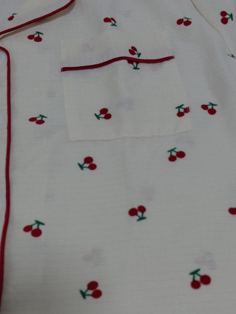 Cherry Print Short Sleeve Pajama Set Size S (Category: Undergarments & Loungewear) located in Taguig. Submitted by ynelshop (Listing ID 1469690701, Image 2). Description: - Style: Cute cherry print pajama set in cream with red piping - Top: Short-sleeve, button-down with a convenient chest pocket - Bottoms: Matching shorts featuring a comfortable elastic waistband - Size: S - Material: Lightweight, soft, and breathable fabric ideal for sleeping o
