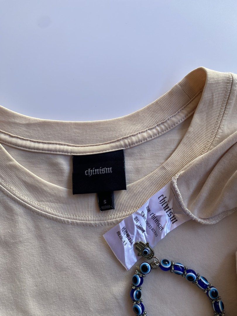 Chinism (Category: Tshirts & Polo Shirts ) located in Kalibo. Submitted by kurt_ismael (Listing ID 1469592482, Image 3). Description: Chinism Actual color: Light cream Width: 21 Length: 28.5 Excellent condition Color rate: 10 Issue: (1) very tiny pinhole on hem back part (not visible when worn kasi nasa baba namang part) Kindly check last pic.