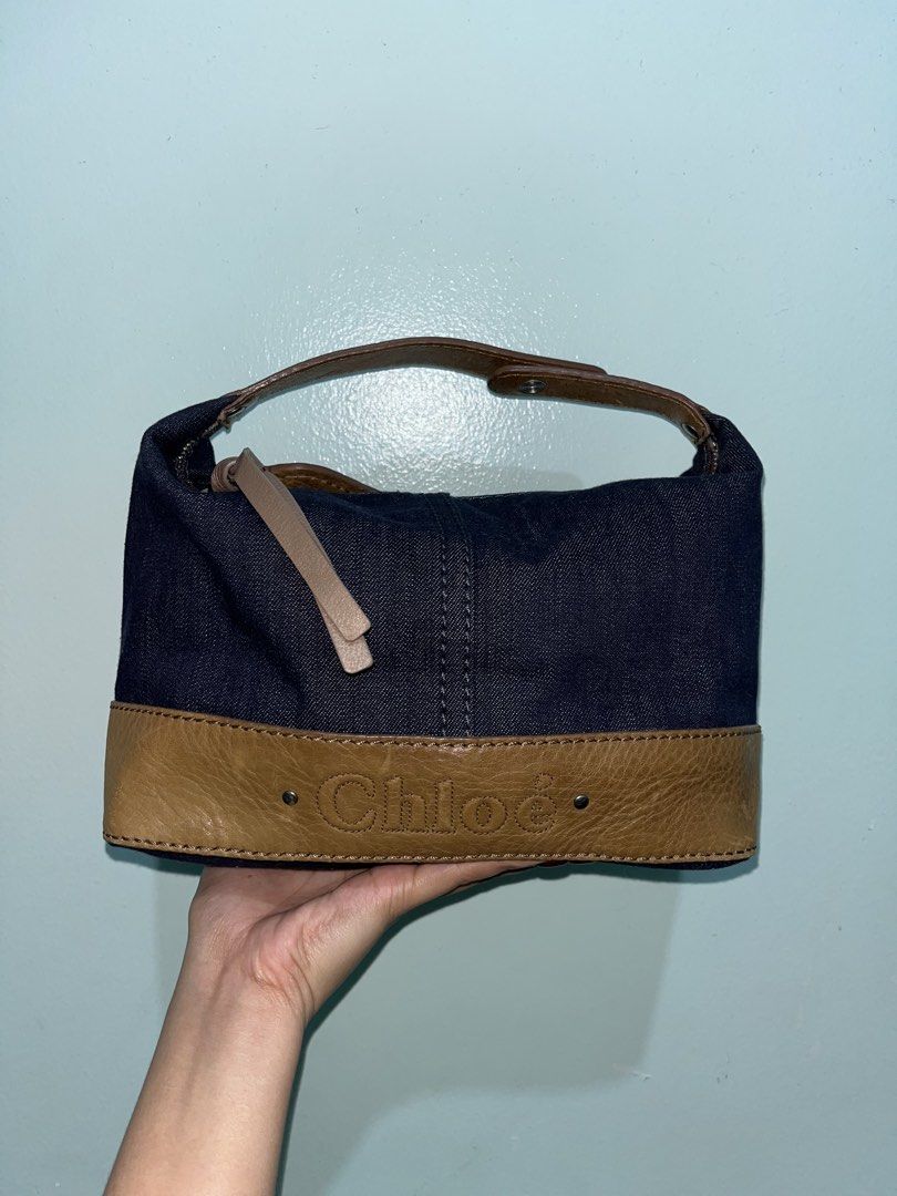 Chloé denim and leather handbag (Category: Luxury Bags & Wallets) located in Manila. Submitted by bags_2.riches (Listing ID 1469744139, Image 1). Description: - Authentic Chloé shoulder bag made from stylish dark blue denim - Features brown leather trim along the bottom with embossed Chloé logo lettering - Secure top zipper closure with metallic hardware and dual leather pull tabs - Comfortable single brown leather strap attached with secure meta
