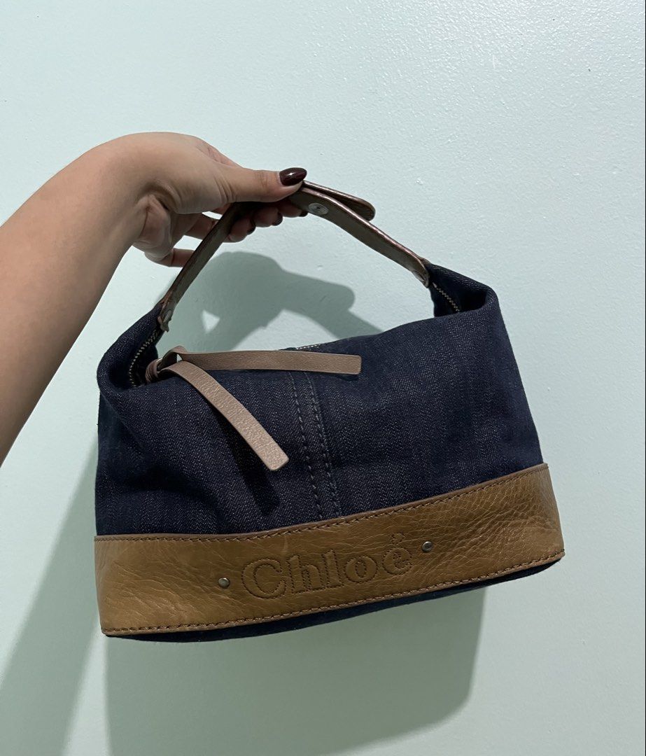Chloé denim and leather handbag (Category: Luxury Bags & Wallets) located in Manila. Submitted by bags_2.riches (Listing ID 1469744139, Image 2). Description: - Authentic Chloé shoulder bag made from stylish dark blue denim - Features brown leather trim along the bottom with embossed Chloé logo lettering - Secure top zipper closure with metallic hardware and dual leather pull tabs - Comfortable single brown leather strap attached with secure meta