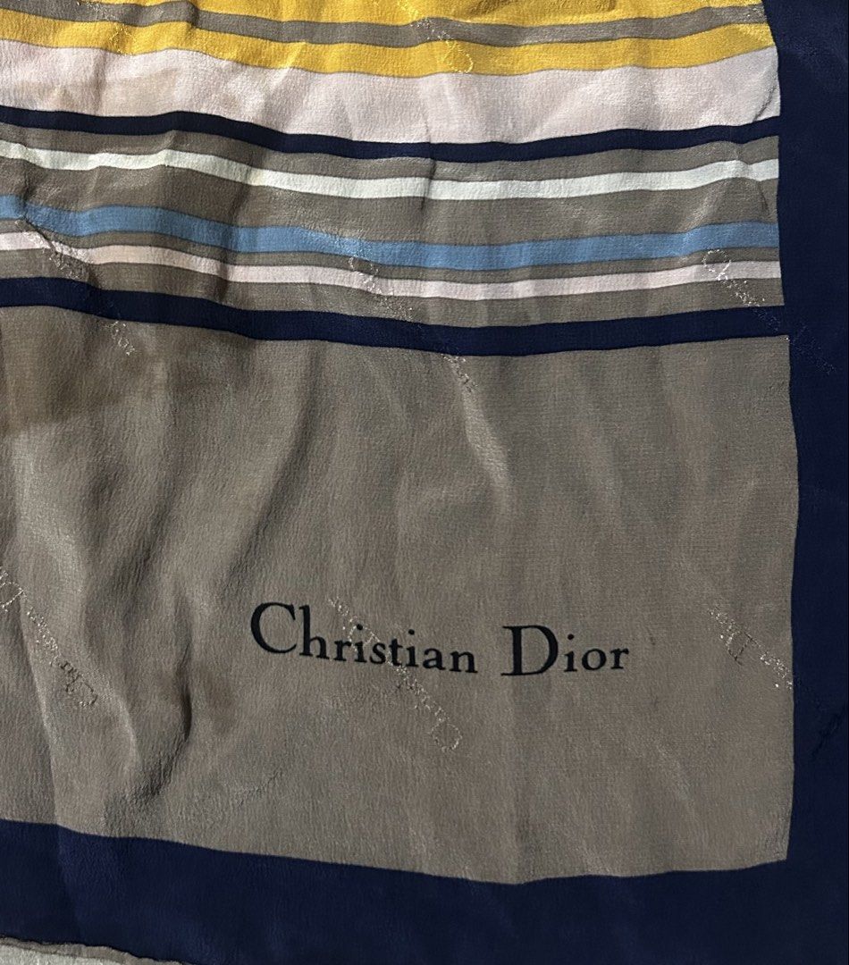 CHRISTIAN DIOR (Category: Scarves) located in Davao. Submitted by sart0ria85 (Listing ID 1469678557, Image 2). Description: - Authentic Christian Dior square silk scarf - Geometric color block design in mustard yellow, olive green, dusty pink, and blue with a navy blue border - Subtle monogram jacquard weave throughout the fabric - Versatile accessory for neck, bag, or hair styling EXCELLENT CONDITION (94/100).