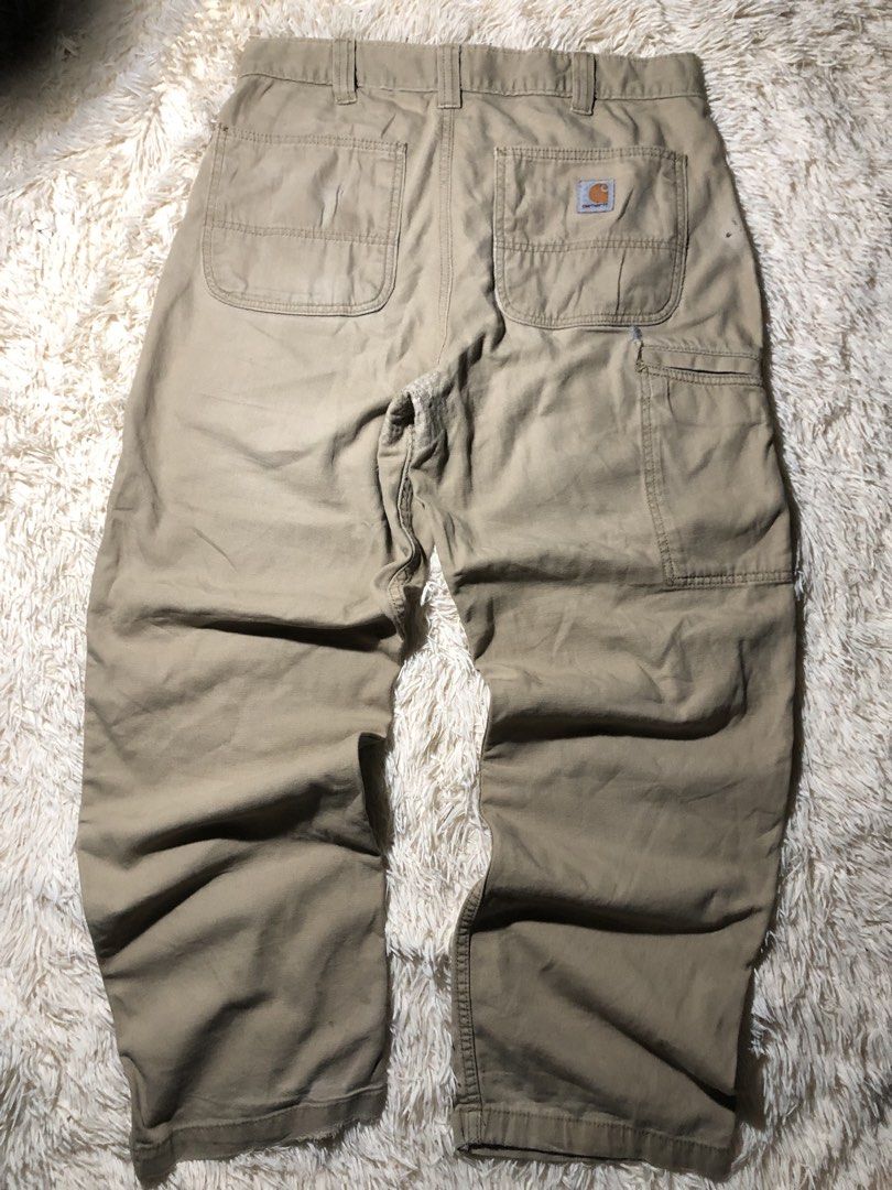Chrome Hearts patched Carhartt Pants (Category: Jeans) located in Maria Aurora. Submitted by kylerikathriftshop101010 (Listing ID 1469710244, Image 2). Description: size 33 40 length 8.6 hem some repairs(see pic) - Brand/Model: Custom Carhartt Relaxed Fit Work Pants - Color: Tan - Size: 33x30 - Details: Black and white leather cross patches on front knees, utility pockets, and hammer loop - Condition: Vintage distressed look with natural wear and