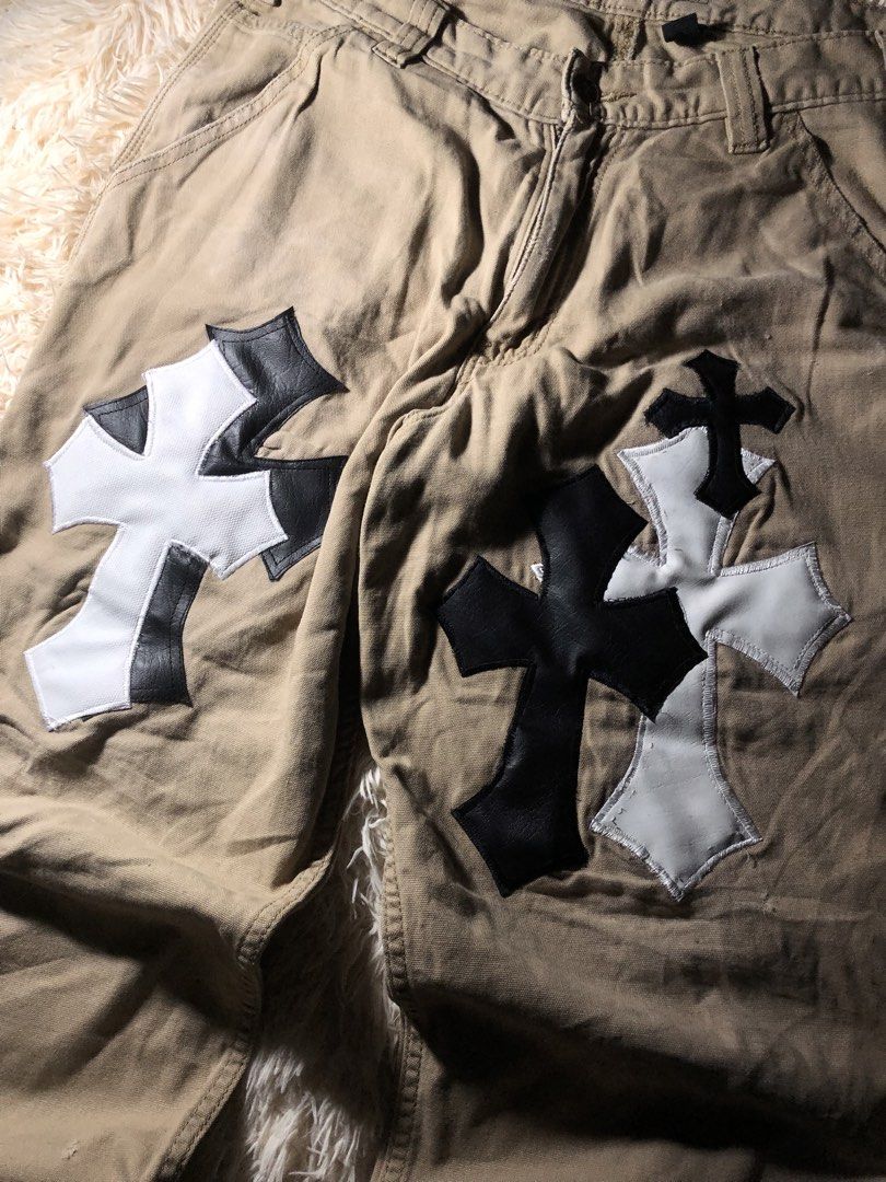 Chrome Hearts patched Carhartt Pants (Category: Jeans) located in Maria Aurora. Submitted by kylerikathriftshop101010 (Listing ID 1469710244, Image 3). Description: size 33 40 length 8.6 hem some repairs(see pic) - Brand/Model: Custom Carhartt Relaxed Fit Work Pants - Color: Tan - Size: 33x30 - Details: Black and white leather cross patches on front knees, utility pockets, and hammer loop - Condition: Vintage distressed look with natural wear and