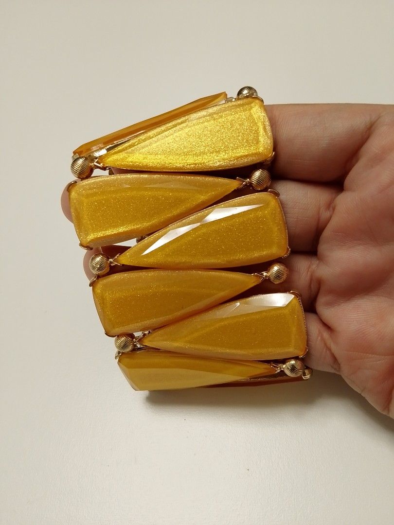 Chunky yellow and gold statement stretch bracelet (Category: Bracelets) located in Manila. Submitted by batchi1019 (Listing ID 1469583030, Image 1). Description: - Vibrant bright yellow and gold statement bracelet - Eye-catching triangular resin/acrylic stones linked with gold-tone metal beads - Convenient slip-on design with a stretchy inner band for easy wear - Adds a gorgeous pop of color to elevate any outfit - Condition: Brand new / Excellen