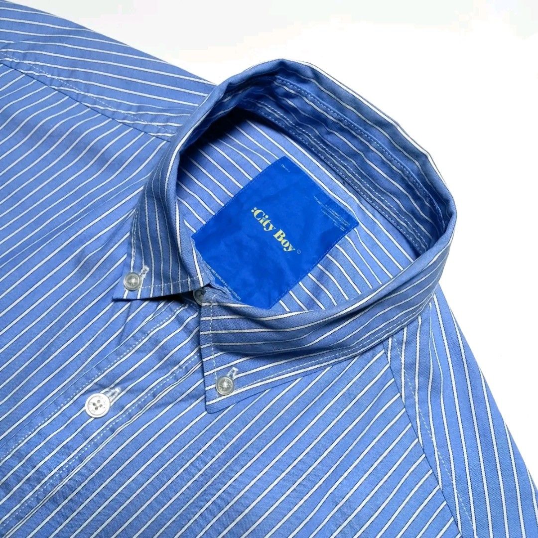 City Boy Blue Striped Button Down Shirt Oversized (Category: Tshirts & Polo Shirts ) located in Caloocan City. Submitted by garciaflor47520 (Listing ID 1469627092, Image 2). Description: - Brand/Style: City Boy striped button-down shirt - Color: Classic blue and white stripes - Fit: Relaxed, oversized fit ideal for streetwear - Details: Classic collar, front button closure, single chest pocket, long sleeves - Condition: Clean with no obvious flaw