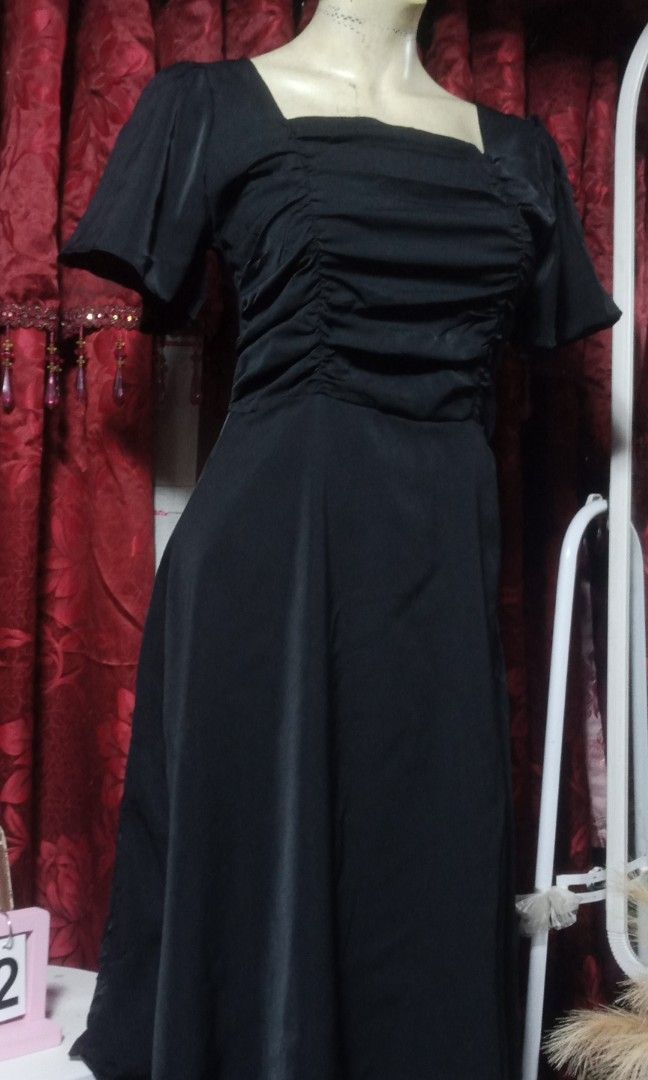 Classic black maxi dress (Category: Dresses) located in Manila. Submitted by wheneity67thifted (Listing ID 1469616610, Image 2). Description: The image shows a classic black midi or knee-length dress featuring a square neckline, ruched front bust detailing, and short flutter or puff sleeves..