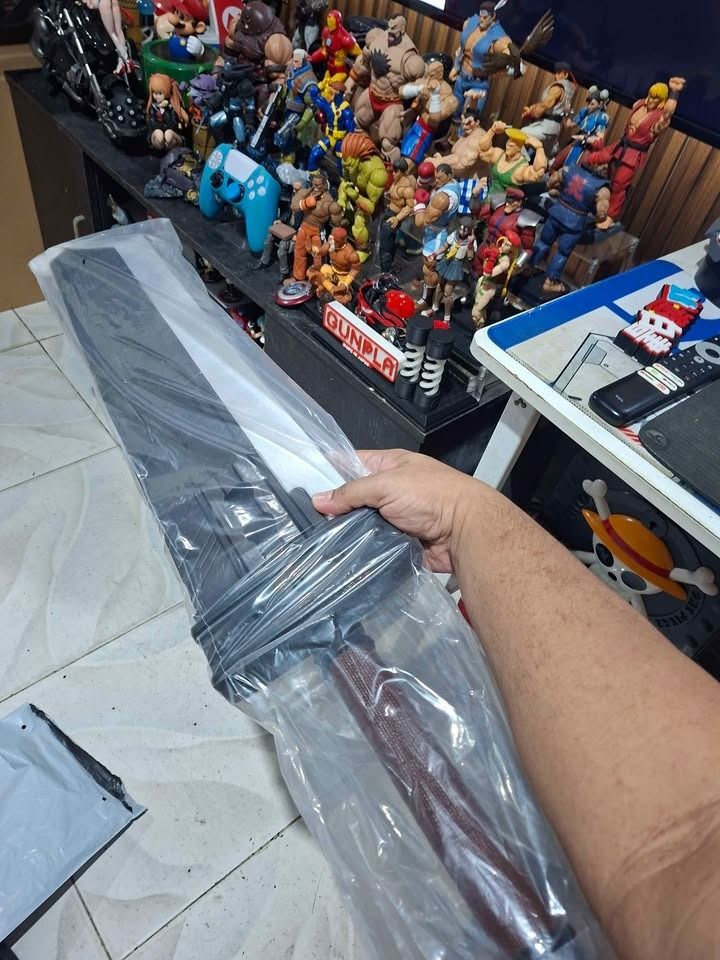 Cloud Strife Buster Sword Replica Final Fantasy VII (Category: Figurines & Statues) located in Imus. Submitted by ToyBlazePH (Listing ID 1469680282, Image 2). Description: - Brand: Final Fantasy Buster Sword replica - Condition: Still sealed in original plastic packaging - Size/Type: Large cosplay prop and display piece - Features: Iconic broad blade design with wrapped hilt - Storage: Stored safely indoors away from elements - Ideal for: Gaming 