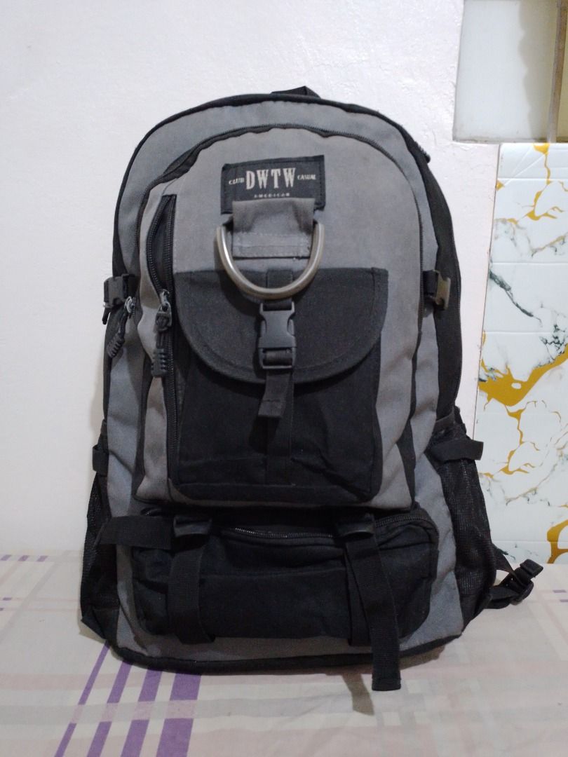 Club DWTW Casual Grey Black Backpack with Multiple Pockets (Category: Backpacks) located in Imus. Submitted by bestfinds_yeth0724 (Listing ID 1469573779, Image 1). Description: - Brand/Model: Club DWTW Casual backpack - Color: Grey and black - Storage: Spacious main compartment, front flap pocket, zipper pockets, and bottom zipped section - Extras: Metañl D-ring detail and mesh side pockets for water bottles - Comfort: Padded shoulder straps with