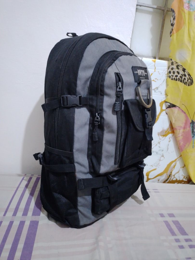 Club DWTW Casual Grey Black Backpack with Multiple Pockets (Category: Backpacks) located in Imus. Submitted by bestfinds_yeth0724 (Listing ID 1469573779, Image 2). Description: - Brand/Model: Club DWTW Casual backpack - Color: Grey and black - Storage: Spacious main compartment, front flap pocket, zipper pockets, and bottom zipped section - Extras: Metañl D-ring detail and mesh side pockets for water bottles - Comfort: Padded shoulder straps with