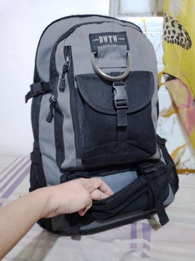 Club DWTW Casual Grey Black Backpack with Multiple Pockets (Category: Backpacks) located in Imus. Submitted by bestfinds_yeth0724 (Listing ID 1469573779, Image 3). Description: - Brand/Model: Club DWTW Casual backpack - Color: Grey and black - Storage: Spacious main compartment, front flap pocket, zipper pockets, and bottom zipped section - Extras: Metañl D-ring detail and mesh side pockets for water bottles - Comfort: Padded shoulder straps with