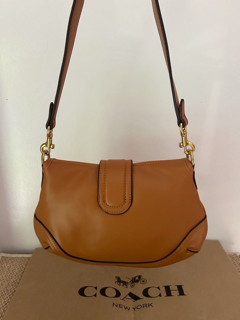 Coach Brown Leather Soho (Category: Luxury Bags & Wallets) located in Legazpi City. Submitted by jjacob_018 (Listing ID 1469680757, Image 3). Description: - Brand: Coach - Material: Rich brown leather with contrast stitching - Hardware: Gold-tone with engraved buckle branding - Strap: Matching detachable shoulder strap included - Condition: Pristine exterior and clean interior, structured silhouette.