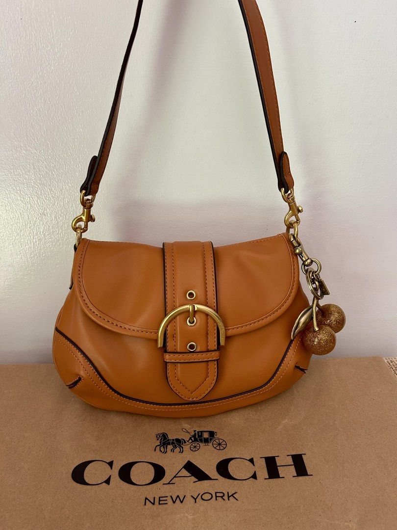 Coach Brown Leather Soho (Category: Luxury Bags & Wallets) located in Legazpi City. Submitted by jjacob_018 (Listing ID 1469680757, Image 1). Description: - Brand: Coach - Material: Rich brown leather with contrast stitching - Hardware: Gold-tone with engraved buckle branding - Strap: Matching detachable shoulder strap included - Condition: Pristine exterior and clean interior, structured silhouette.