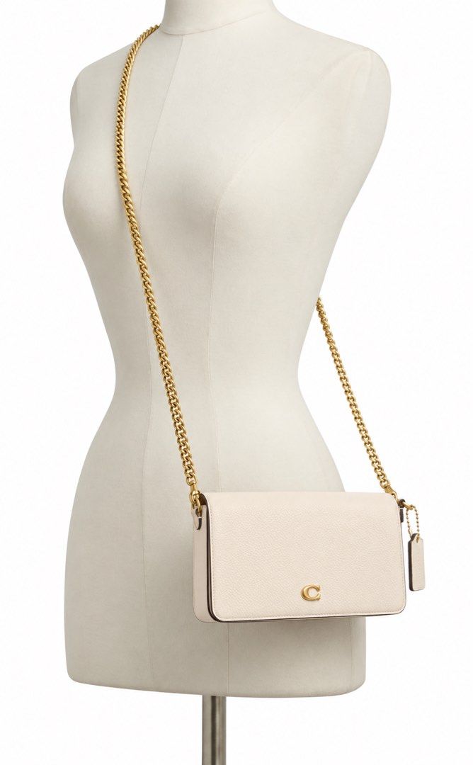 Coach Chain Crossbody Bag Off-White (Category: Luxury Bags & Wallets) located in Pasay City. Submitted by jan_ann (Listing ID 1469638080, Image 2). Description: - Authentic Coach crossbody bag - Elegant off-white leather with gold-tone chain strap and hardware - Signature small metal C logo on front flap - Includes matching hanging leather tag - Structured rectangular shape with clean stitching - Compact size, perfect for essentials orig price 44