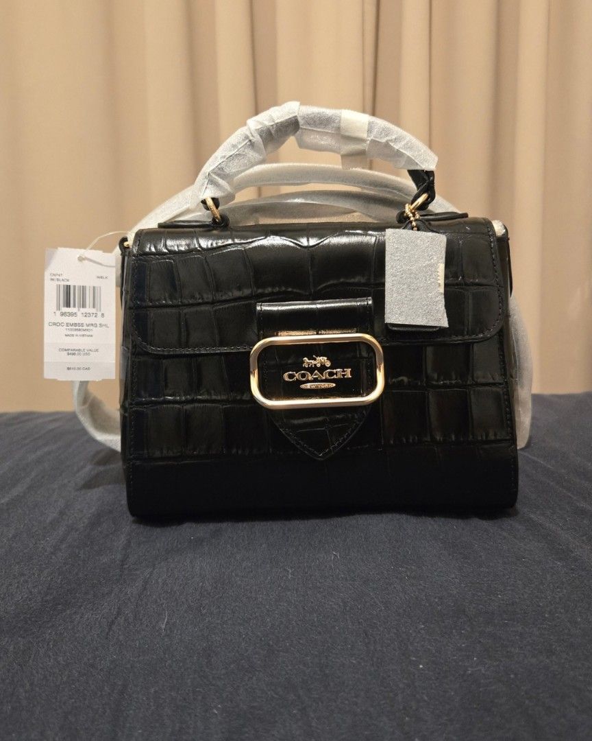 Coach Croc Embossed Morgan Top Handle Satchel Black (Category: Luxury Bags & Wallets) located in San Juan City. Submitted by paulasfinds (Listing ID 1469714093, Image 1). Description: - Authentic Coach Morgan Top Handle Satchel in black crocodile-embossed leather - Elegant gold-tone hardware with front logo buckle - Versatile design with top carry handle and detachable shoulder/crossbody strap - Secure snap closure with fabric-lined interior, ins