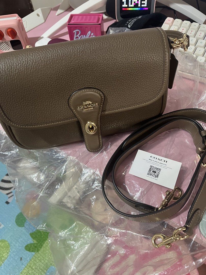 Coach Hadley Darkstone (Category: Luxury Bags & Wallets) located in Taguig. Submitted by shairamaecruz (Listing ID 1469682740, Image 2). Description: - Authentic Coach shoulder bag in Darkstone - Elegant gold-tone hardware and classic turnlock closure - Includes a removable leather strap for versatile styling - Pristine exterior and clean interior.