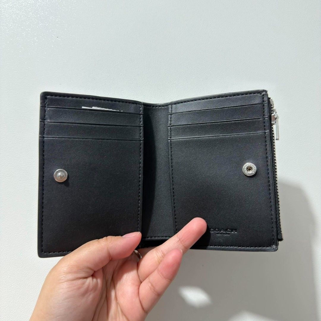 Coach PBL LTR BIFLD WLT Black Wallet (Category: Wallets & Card holders) located in Cabanatuan. Submitted by luckypenguin.e2a414 (Listing ID 1469245508, Image 2). Description: - Authentic Coach bifold wallet in classic black pebble leather - Brand new with original retail price tag attached - Convenient side zip coin pocket and secure snap closure - Multiple card slots and spacious cash compartment - Sleek silver-tone hardware and clean interior l